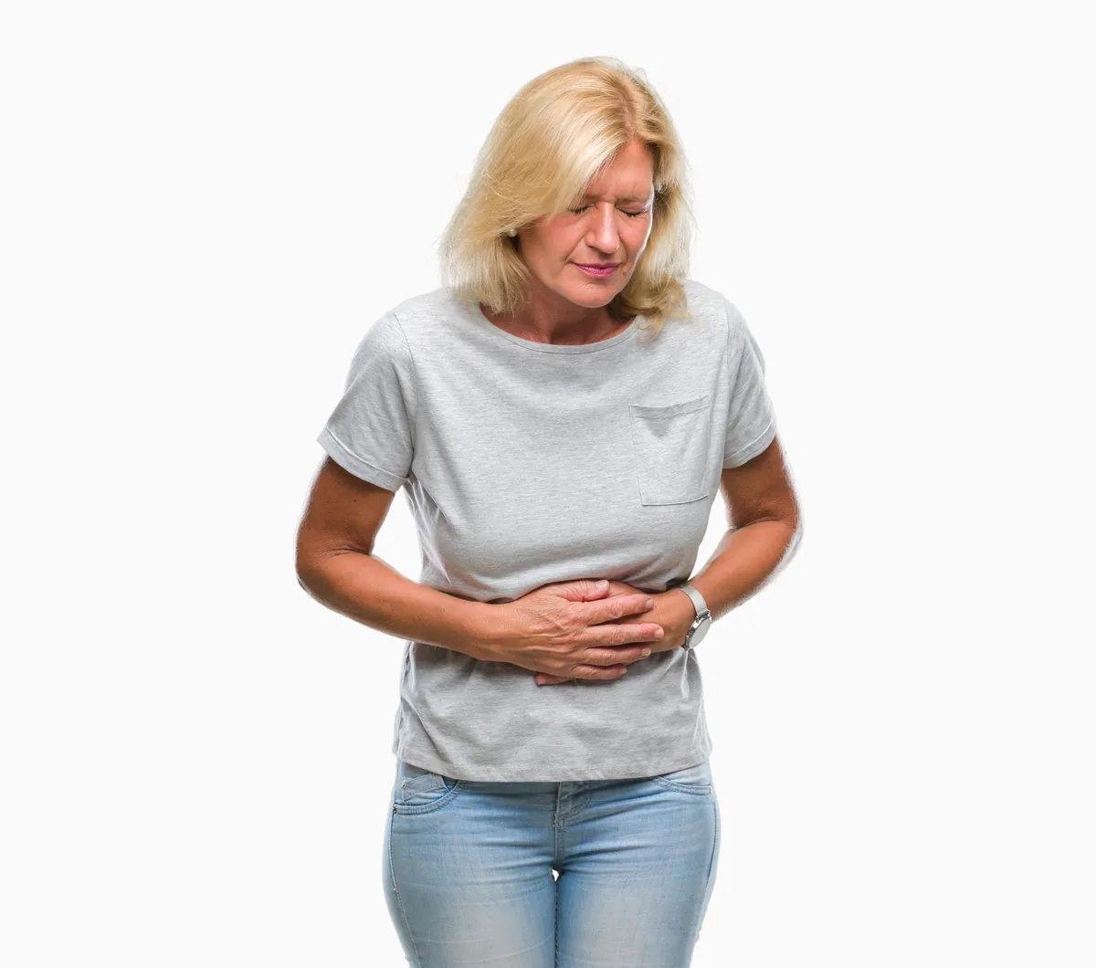 Woman holding her stomach with both hands against a white background